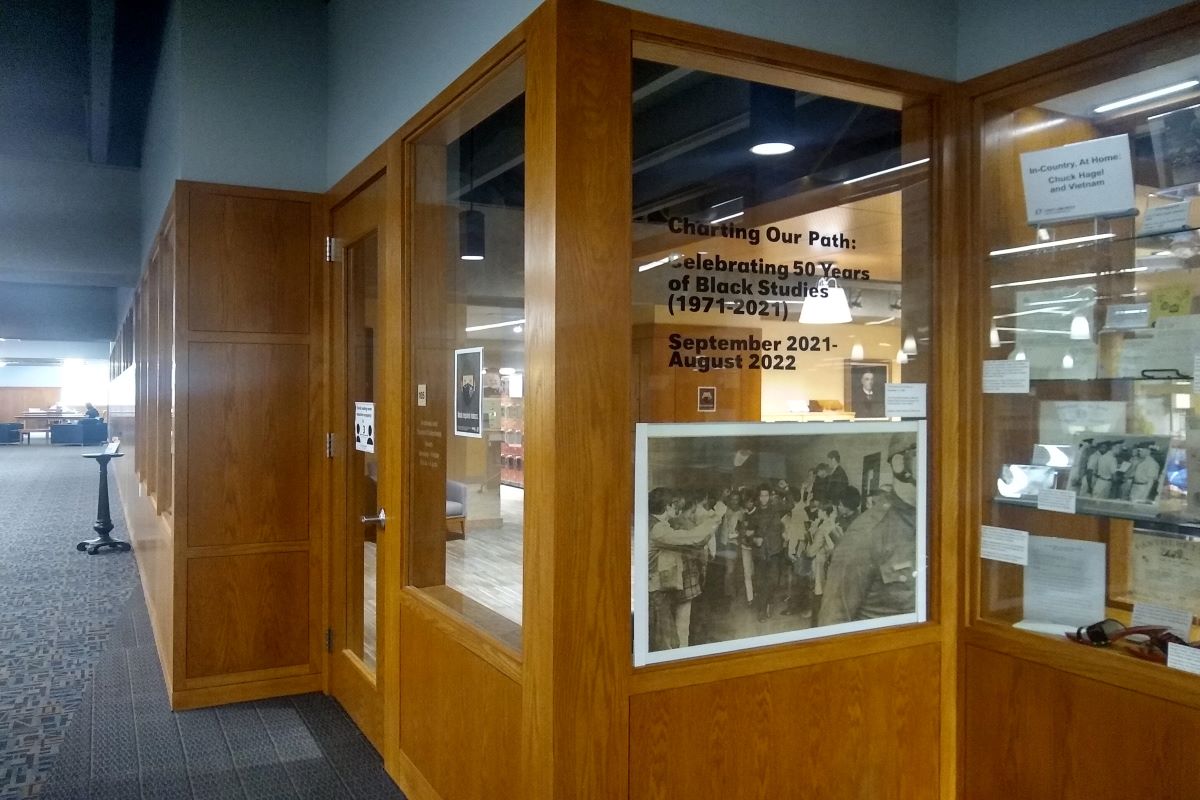 enlarged photo of student protestors hung on a glass wall