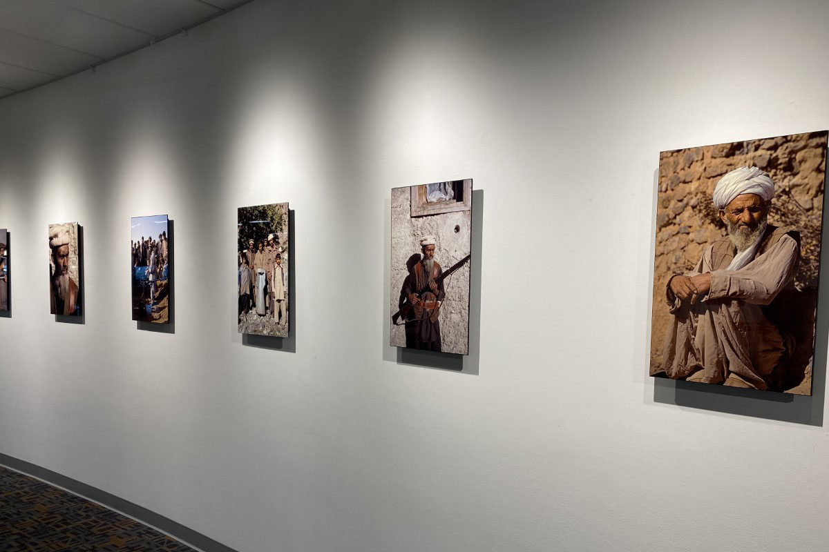 framed photos hanging on a white wall