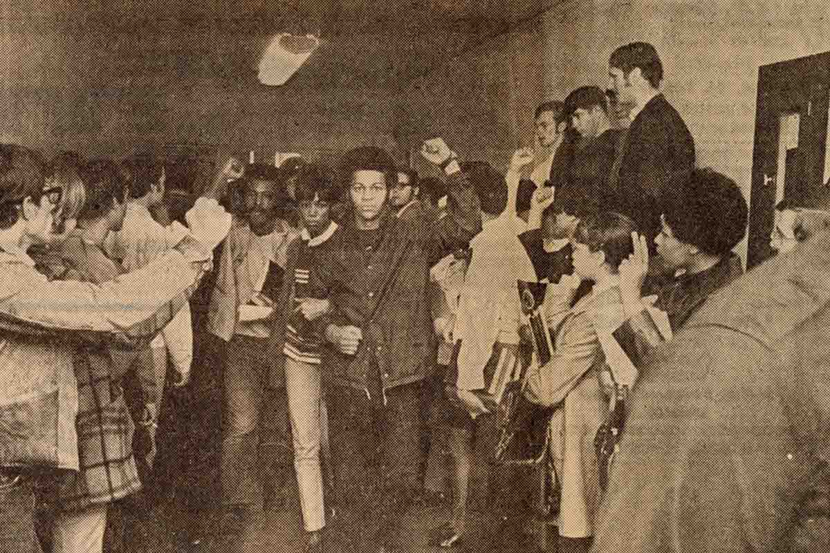 black and white photo of students protesting in a hallway