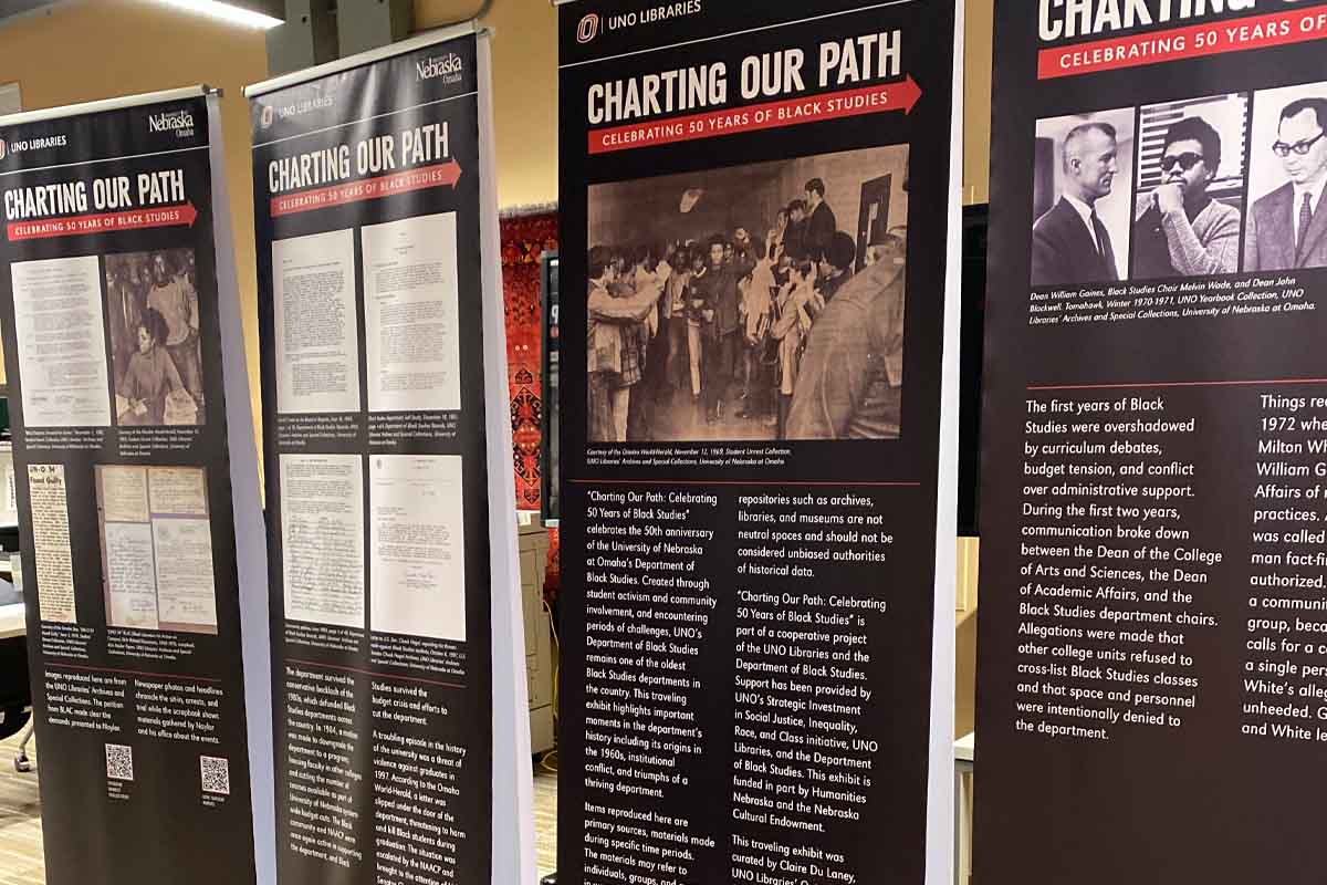 standing poster with words and archival photos on it, all associated with the Department of Black Studies