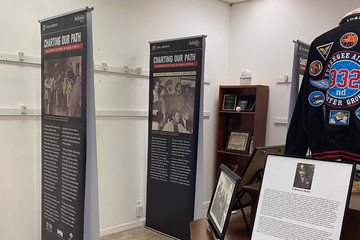 standing poster with words and archival photos on it, all associated with the Department of Black Studies