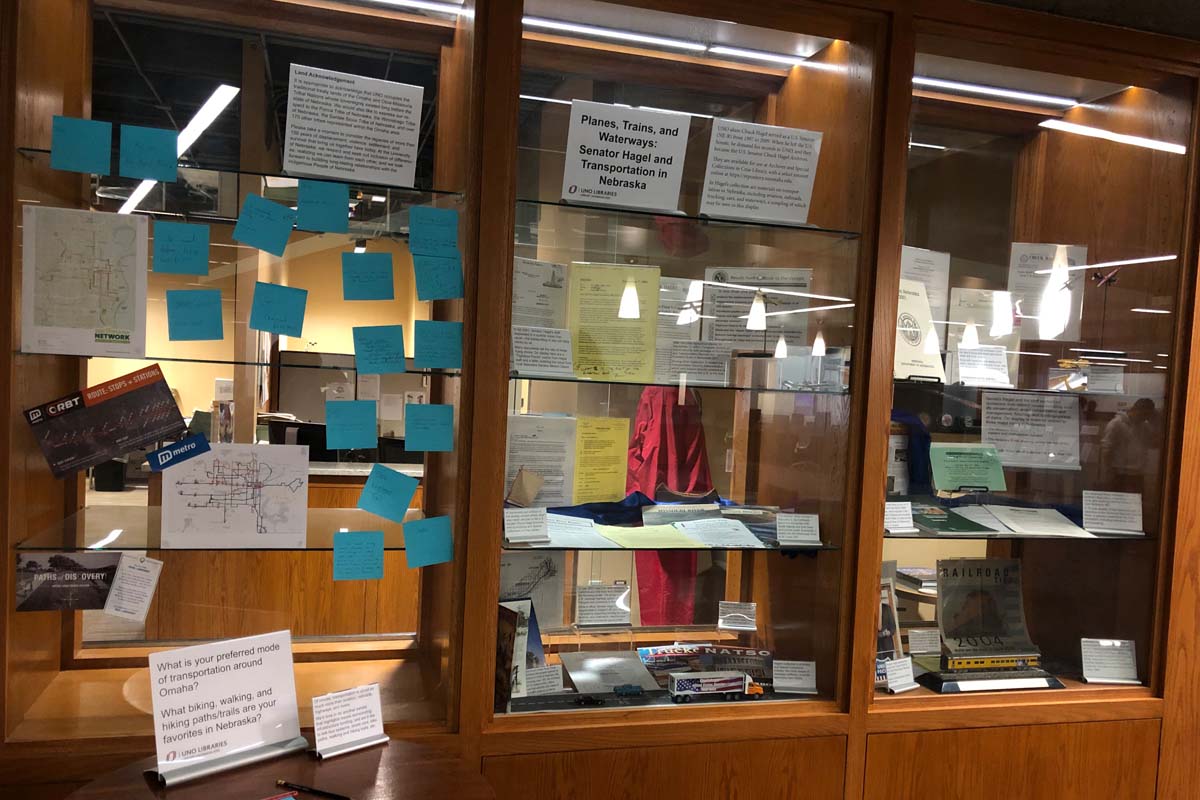 Exhibit cases filled with letters, reports, and other documents on display
