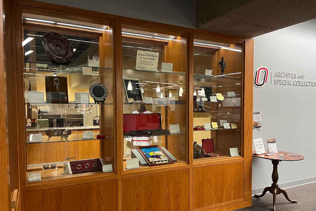 a wooden built in display area with papers and items from the Hagel archives