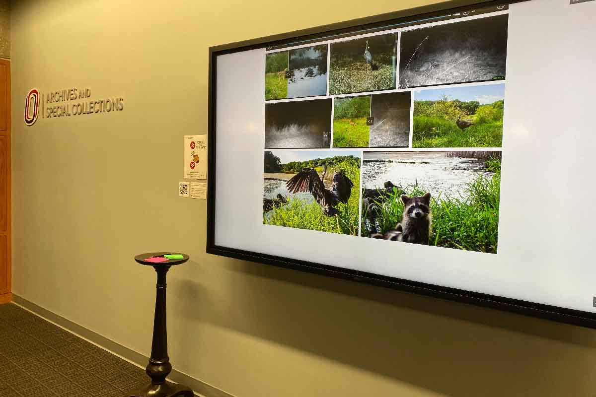 the Turkey Creek Preserve digital screen on the wall next to the archives and special collections space