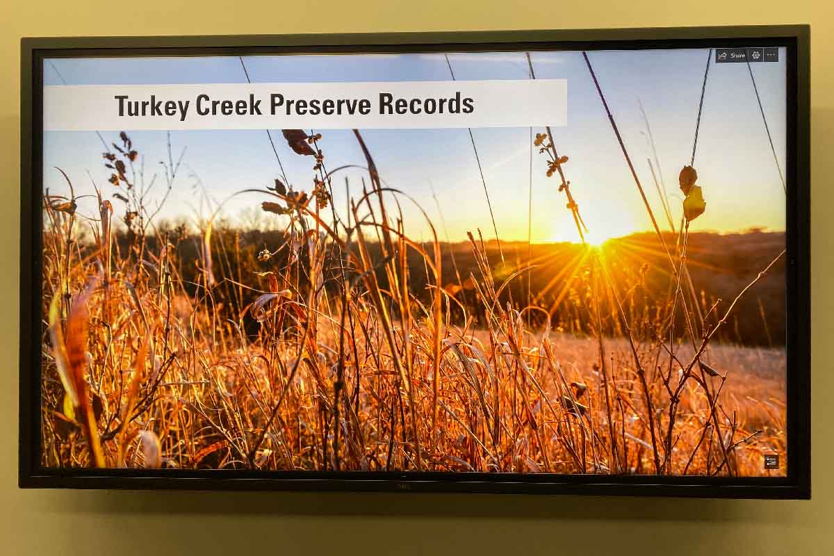 television screen with the digital Turkey Creek Preserve exhibit 