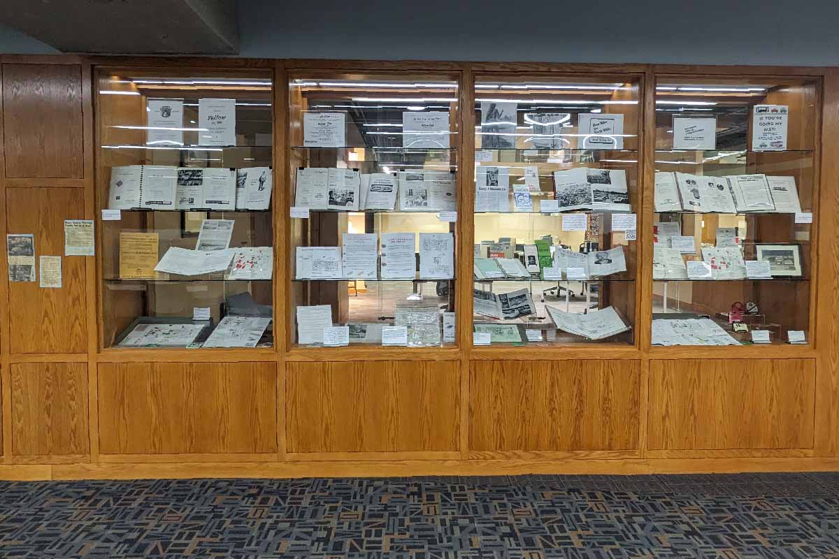 wooden and glass shelves with ephemera and other pieces about the history of UNO parking