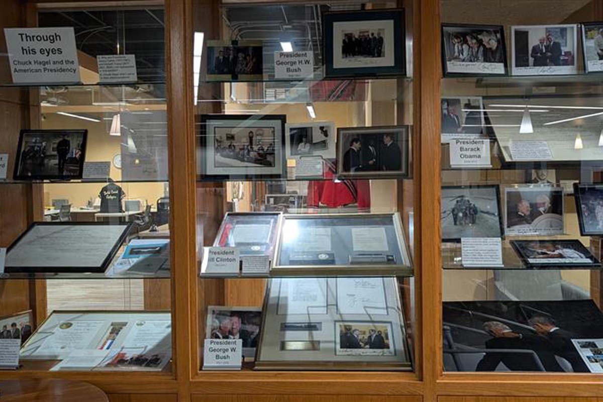 Built in wooden and glass shelves with photos and items about Senator Chuck Hagel and his presidential connections.