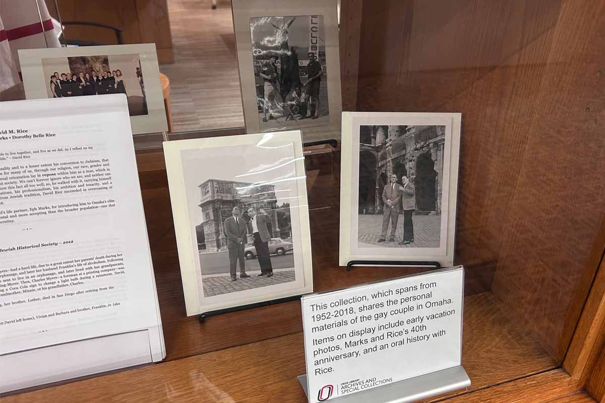 Display case with black and white photos and a descriptive sign about the collection.