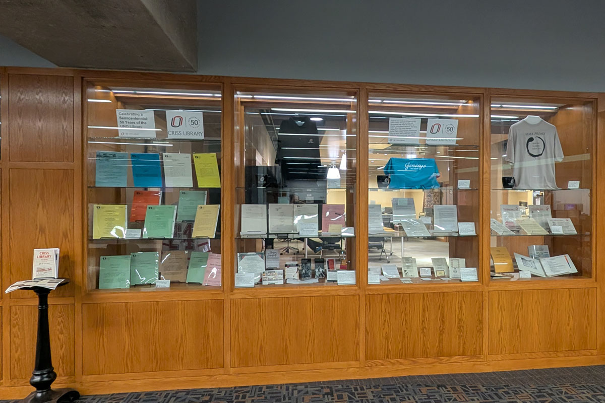 Built in wooden display shelves with ephemera, and other items associated with Criss Library and the 50th anniversary of Criss Library.