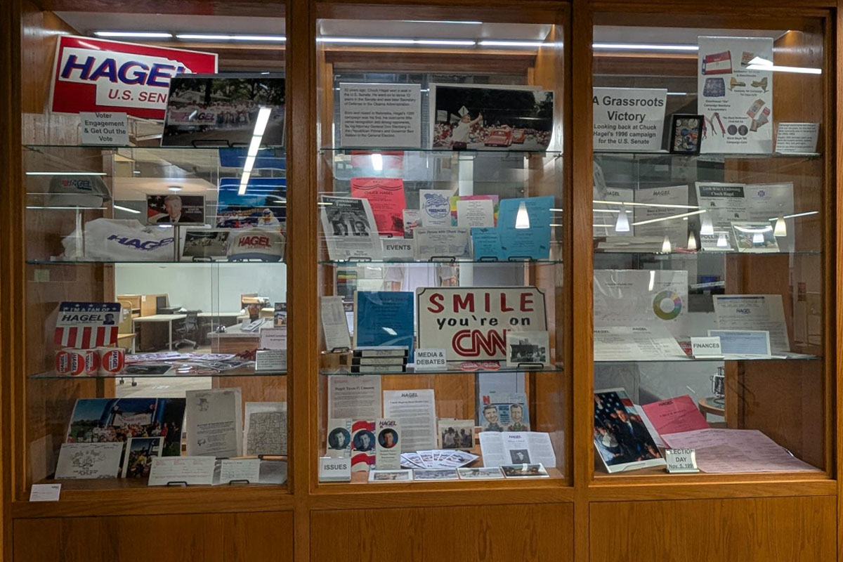 Glass and wooden built in display cabinets. They have ephemera and other information about Chuck Hagel's 1996 U.S. Senate run.