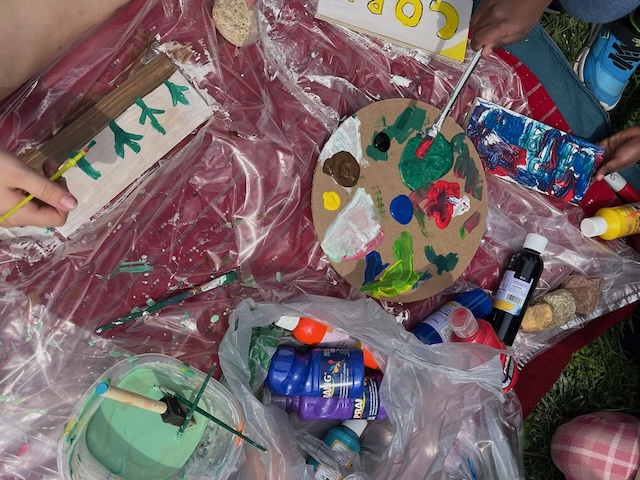 paint, wooden signs, and children helping to create art