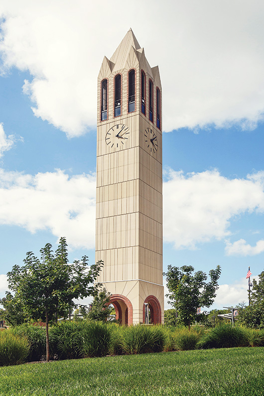 UNO's clocktower campanile on UNO's campus with the sky in the background.