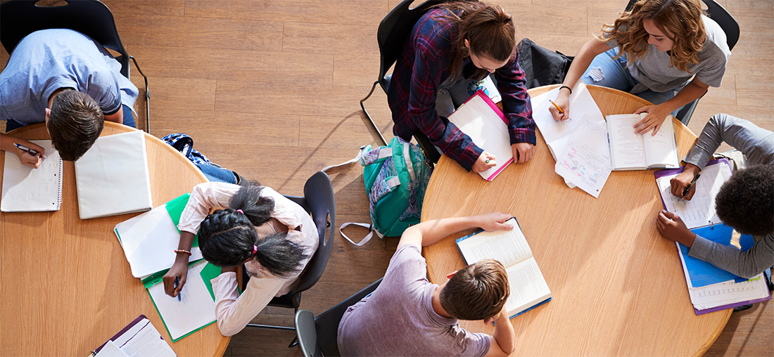 overhead view of multiple students working in study hall.