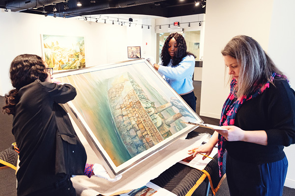 A student and partner examine artwork inside a gallery during a civic engagement project.