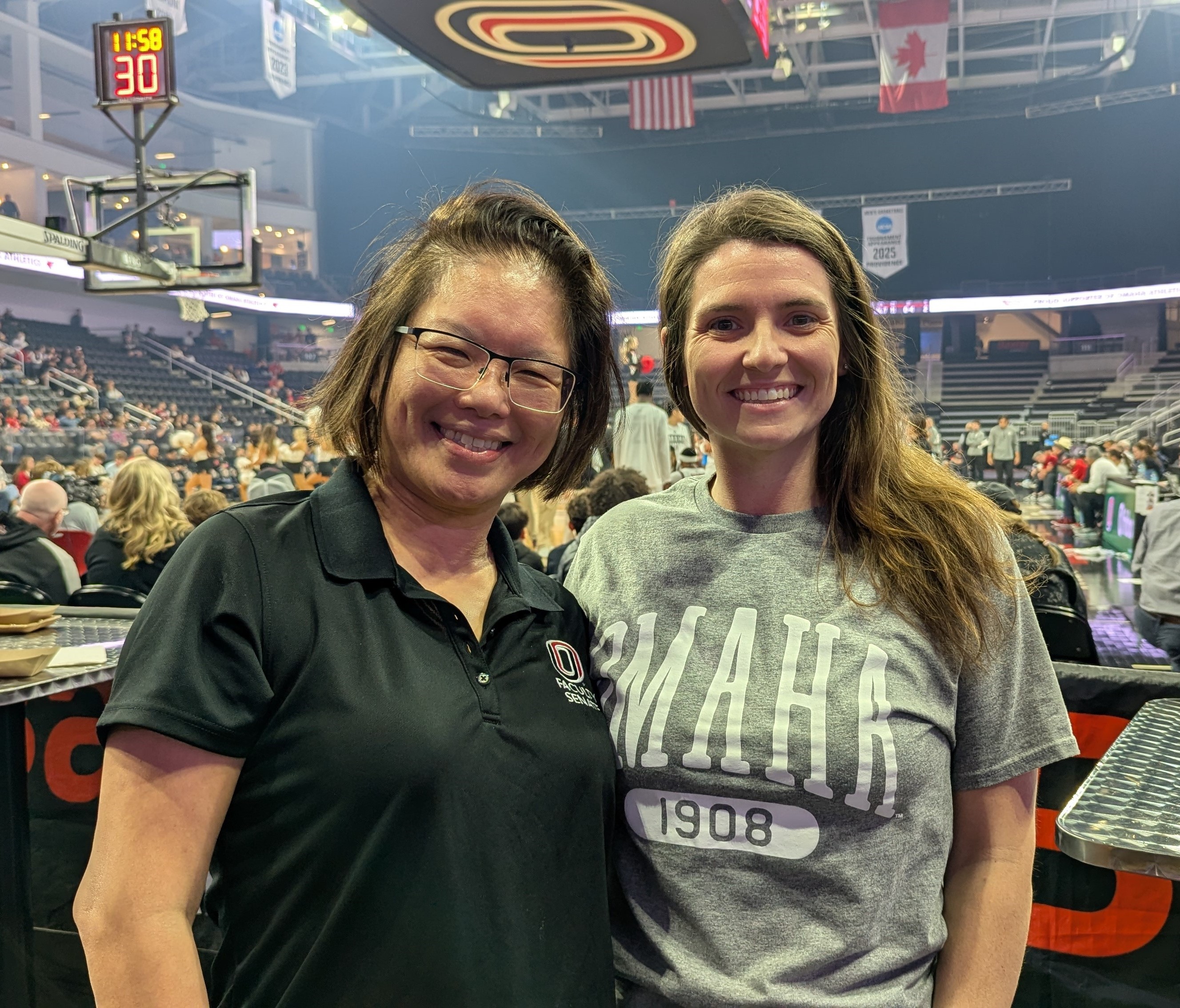 Faculty Senate President Patty Bick and Staff Advisory Council President Ashley Ostranski smiling and posing in the Baxter Arena