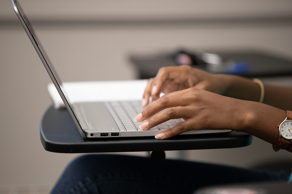 hands typing on computer