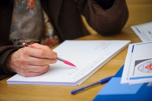 a person uses an automatic pencil to read a ledger