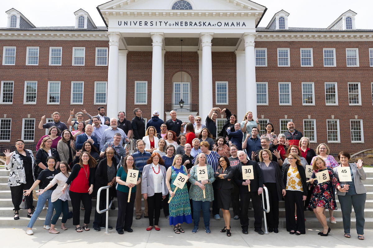 uno employees group together to take a picture to celebrate work anniversaries