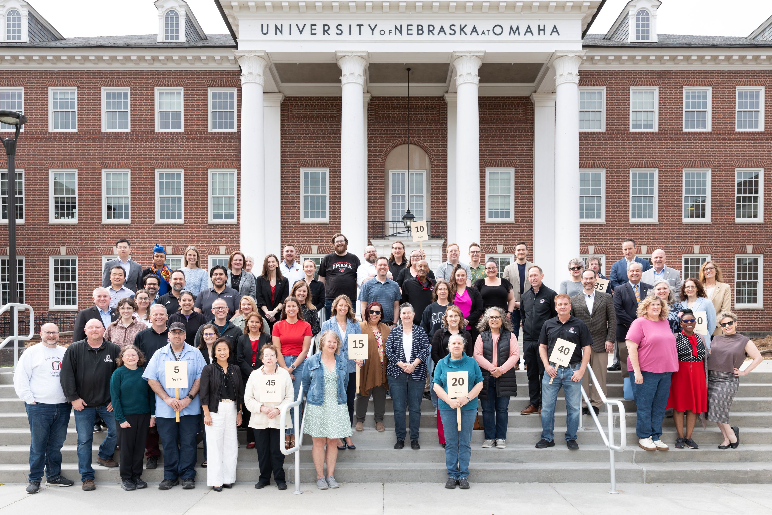 uno employees group together to take a picture to celebrate work anniversaries