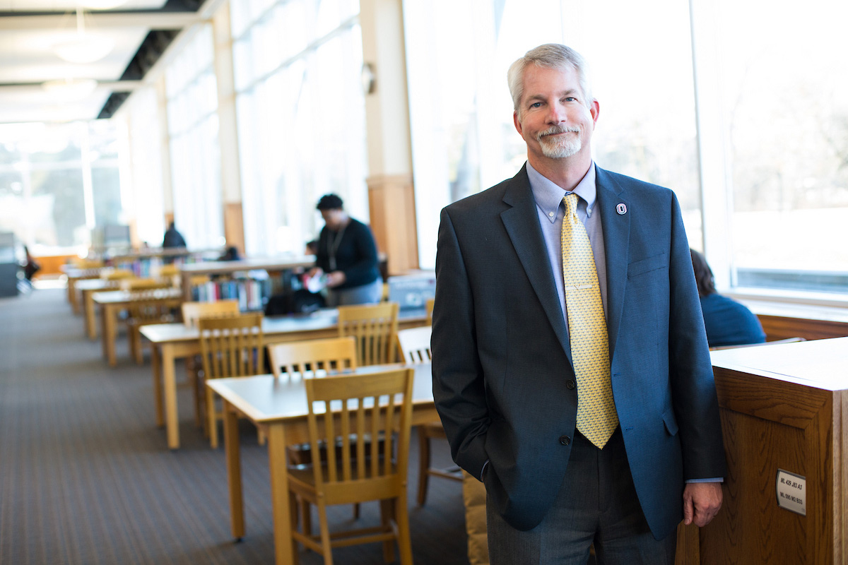 David Richards, outgoing Dean of Criss Library, poses in the library.