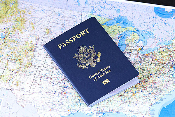 a us passport laying on top of a US map