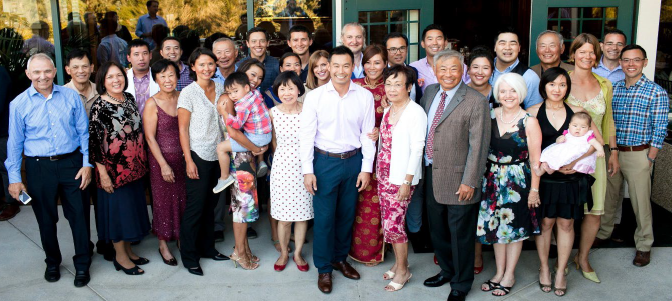 A large family poses together for a group photo.
