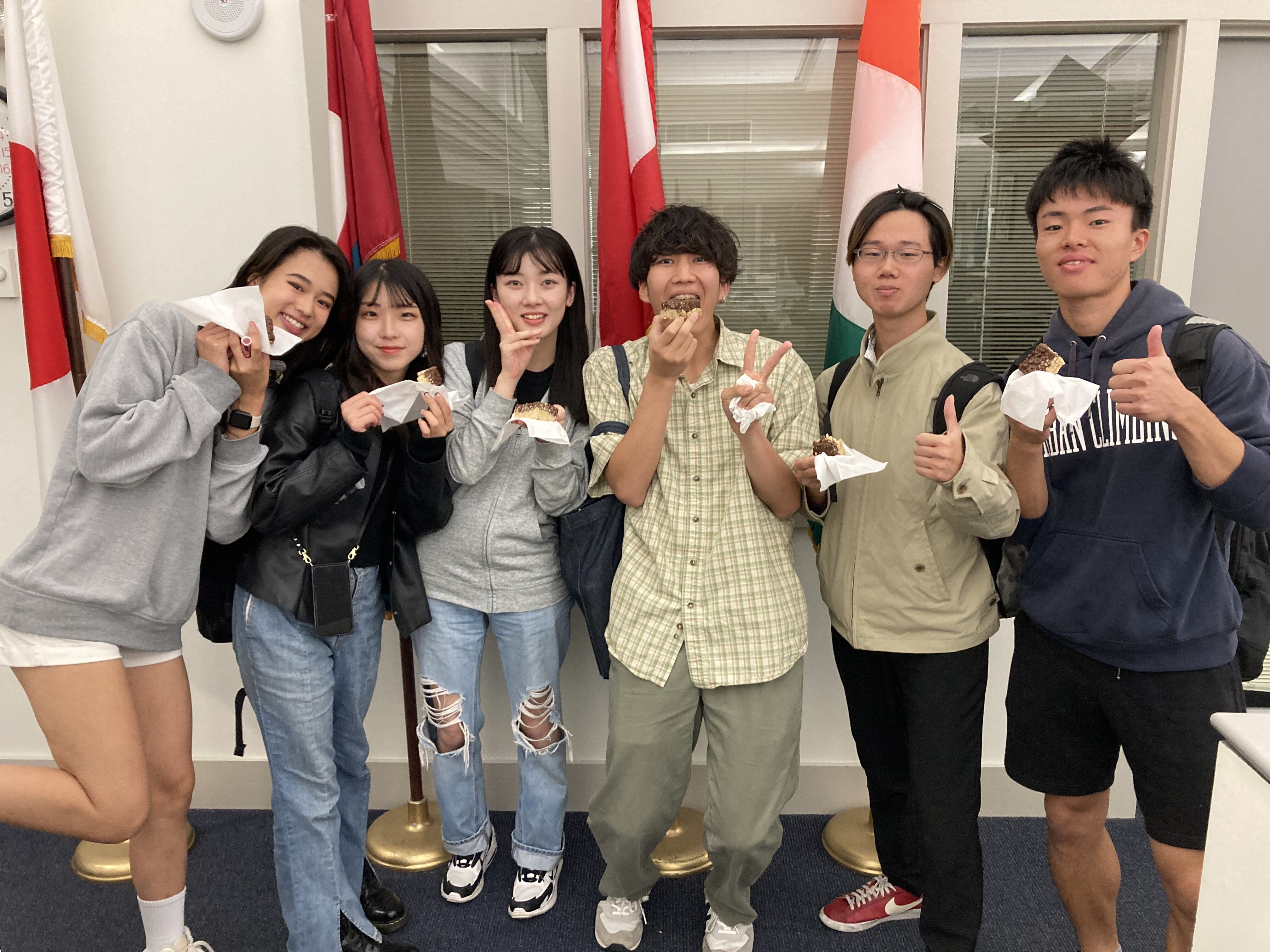 ILUNO students eating treats in the office