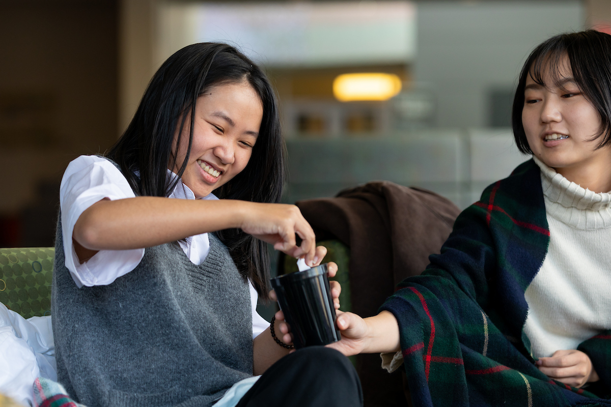 IEP student choosing a piece of paper out of a cup.