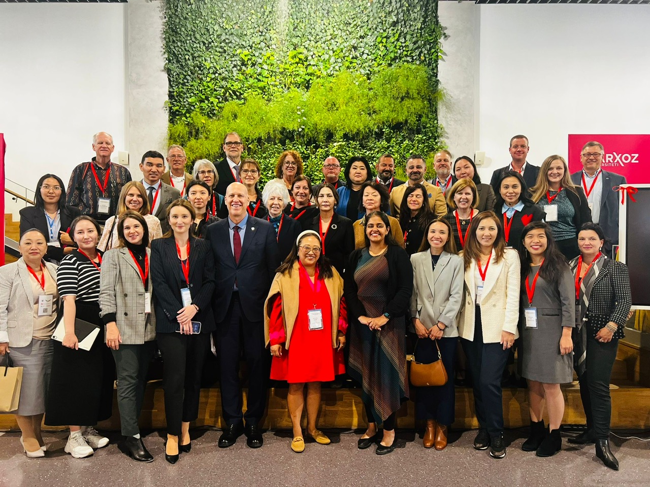group photo in front of a large living wall