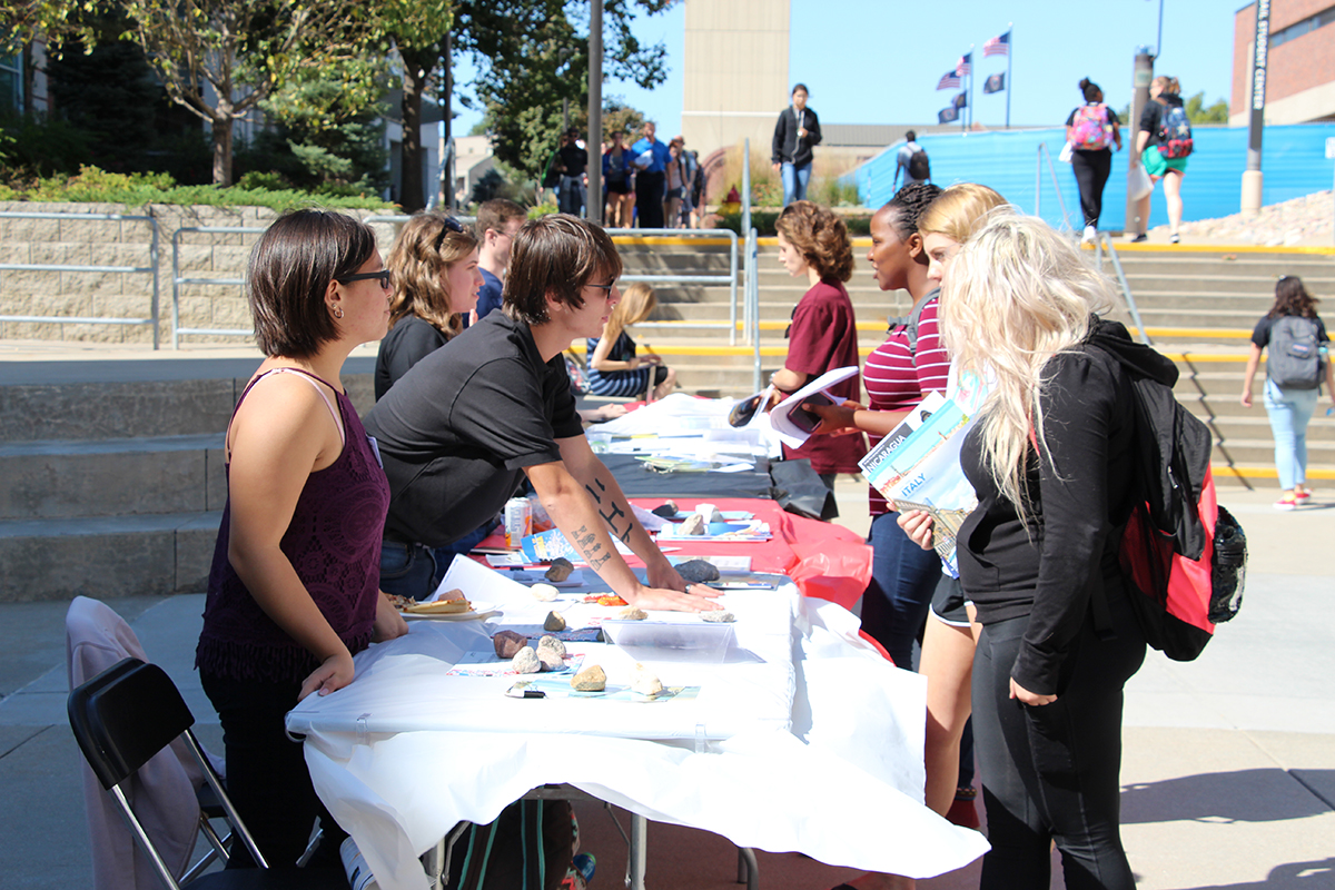Students representatives and student guests speak to each other at tables at the study abroad fair