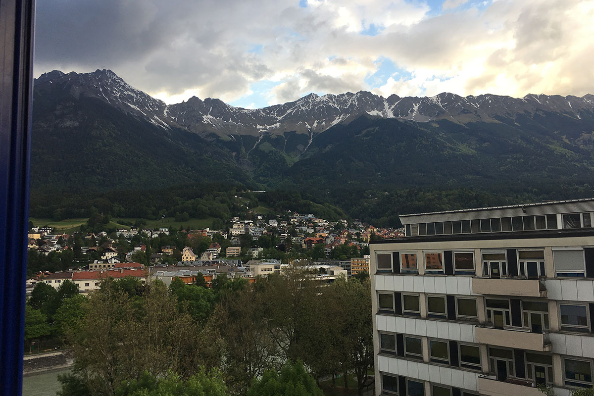 Scene of mountains and buildings as viewed from the window of student housing in Innsbruck, Austria