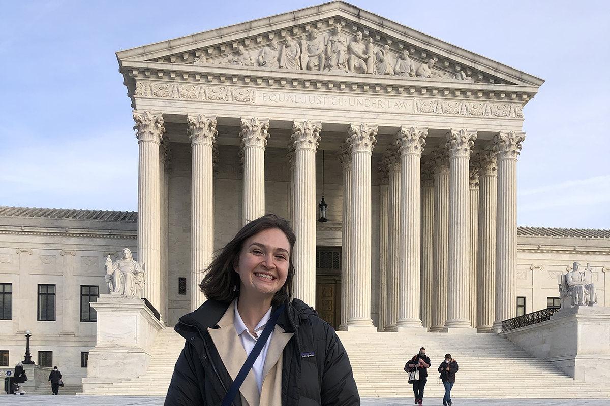 Student stands in front of the US Supreme Court Building