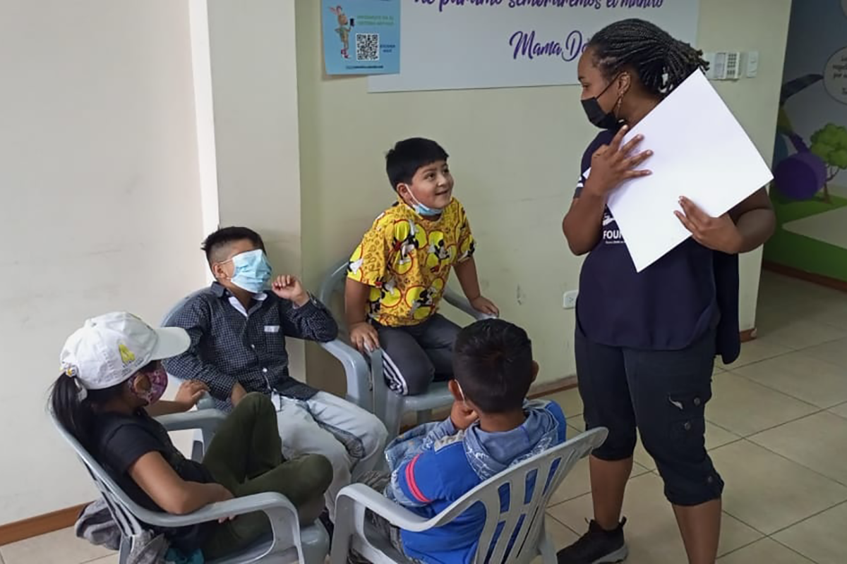 A teacher stands near a small group of students