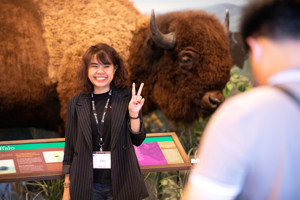 a YSEALI fellow poses in front of a bison display at the Durham Museum.