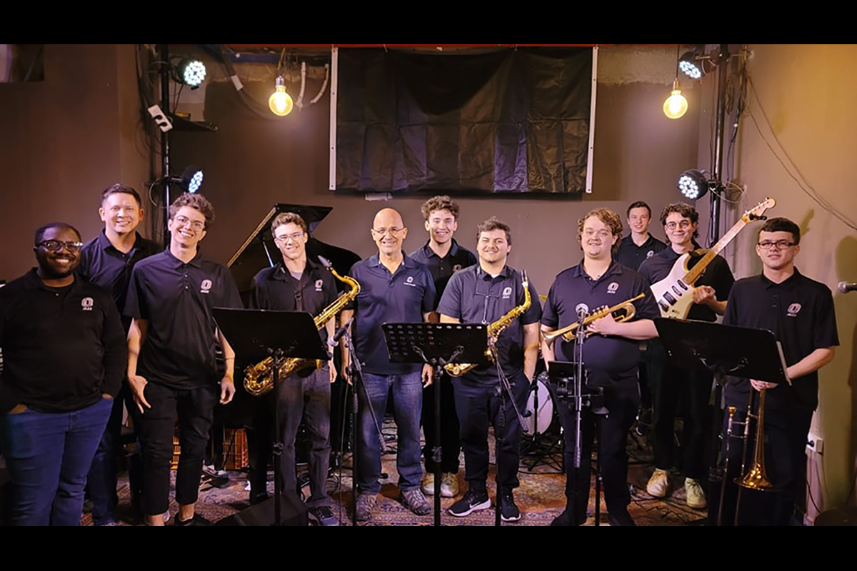 UNO Jazz Combo at a club in Mitzpe Ramon, standing on stage with instruments