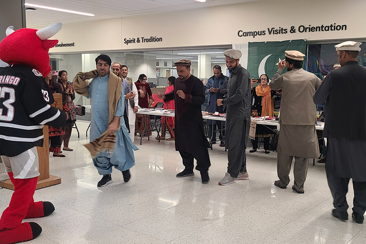 Pakistani English teachers dance with Durango in Milo Bail Student Center