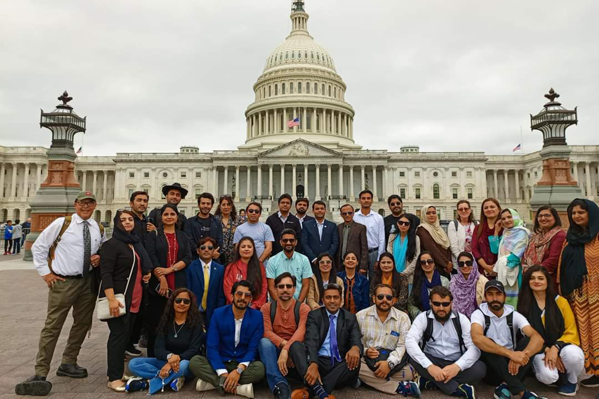 Group of Pakistani teachers poses in front of the U.S. Capitol Building.