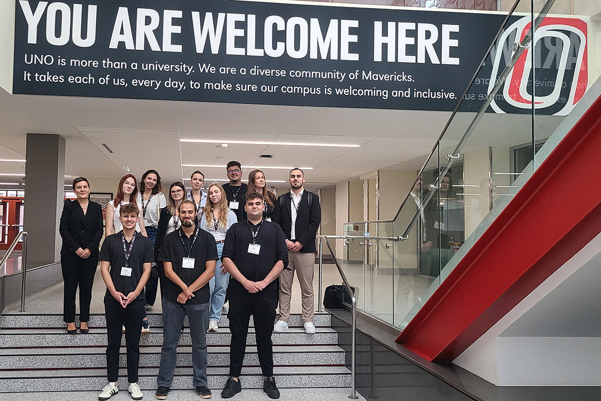 BOLD fellows in the UNO Student Center near the "You Are Welcome Here" sign