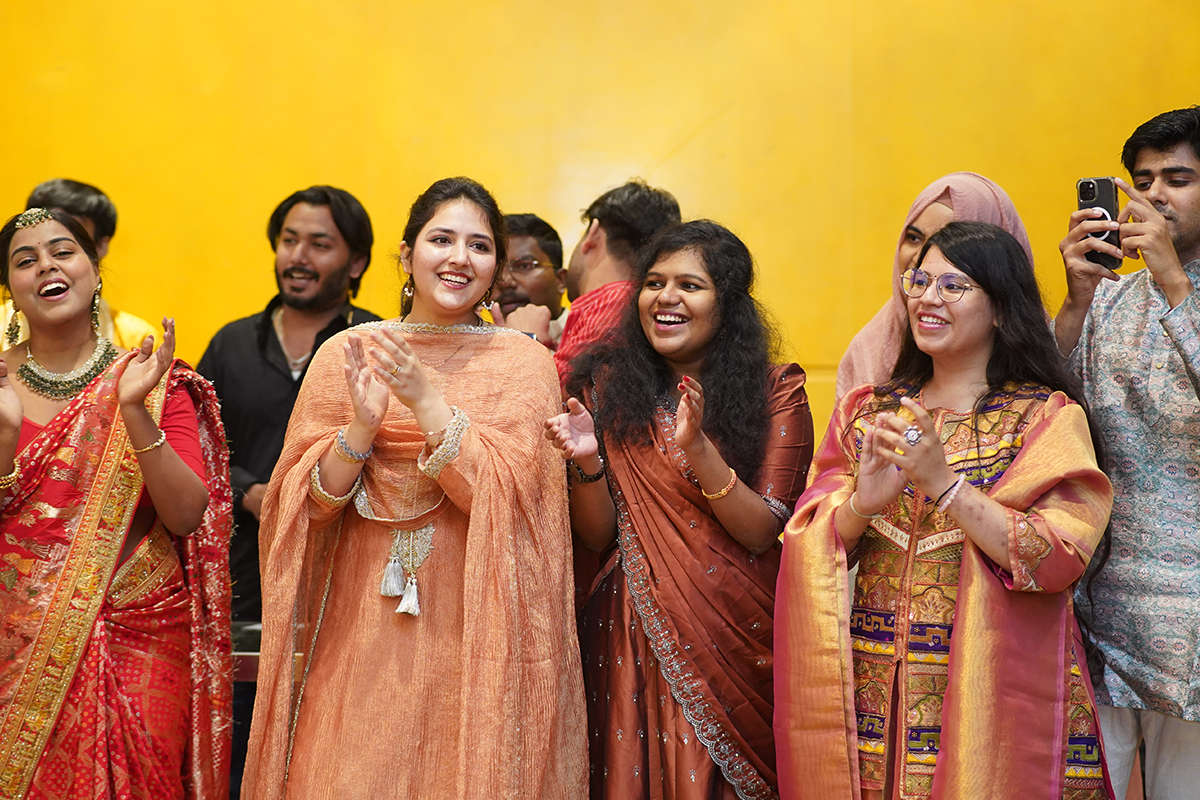 People standing, smiling, and clapping.