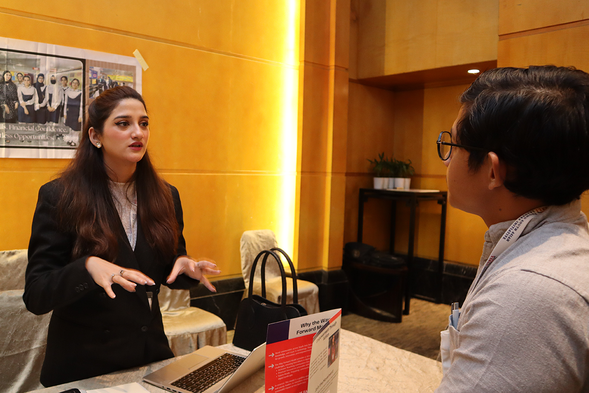Women speaks to a man at a tabling event.
