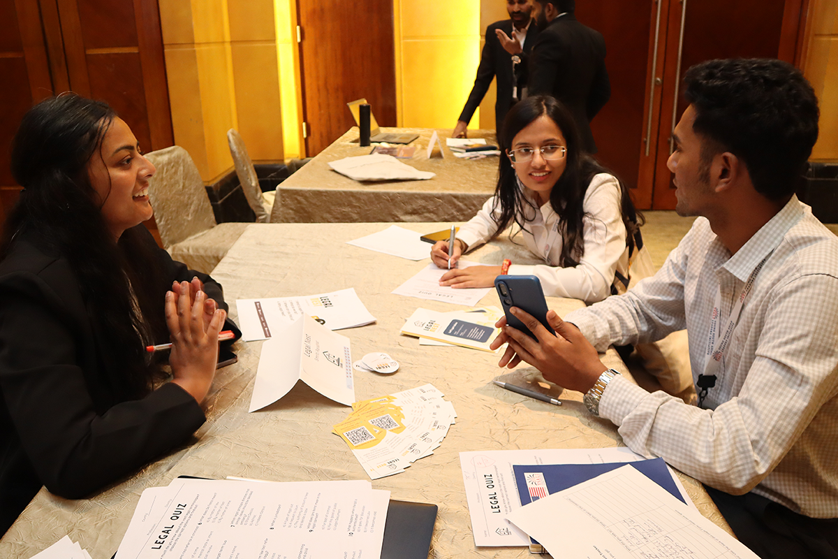 A group sits around a table chatting.