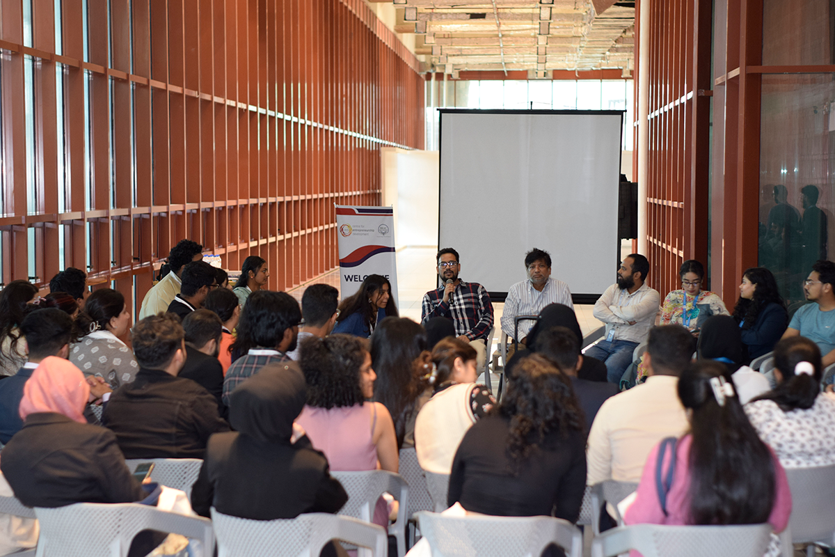 Group sitting together in a meeting hall at a university.