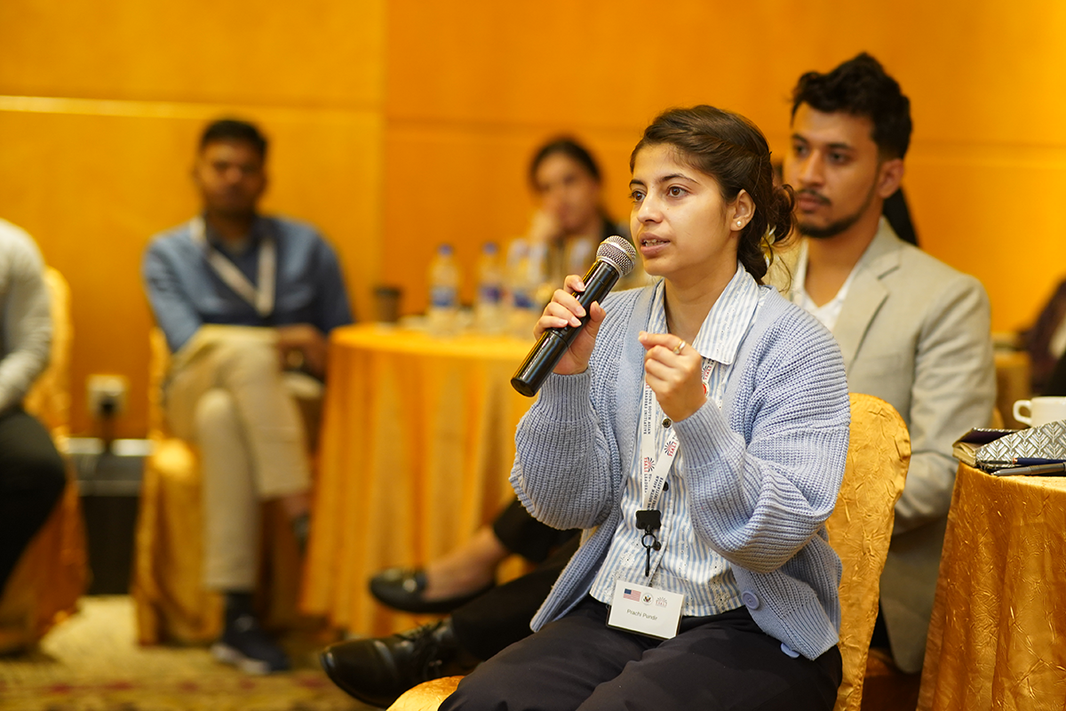 Woman speaks into a microphone.