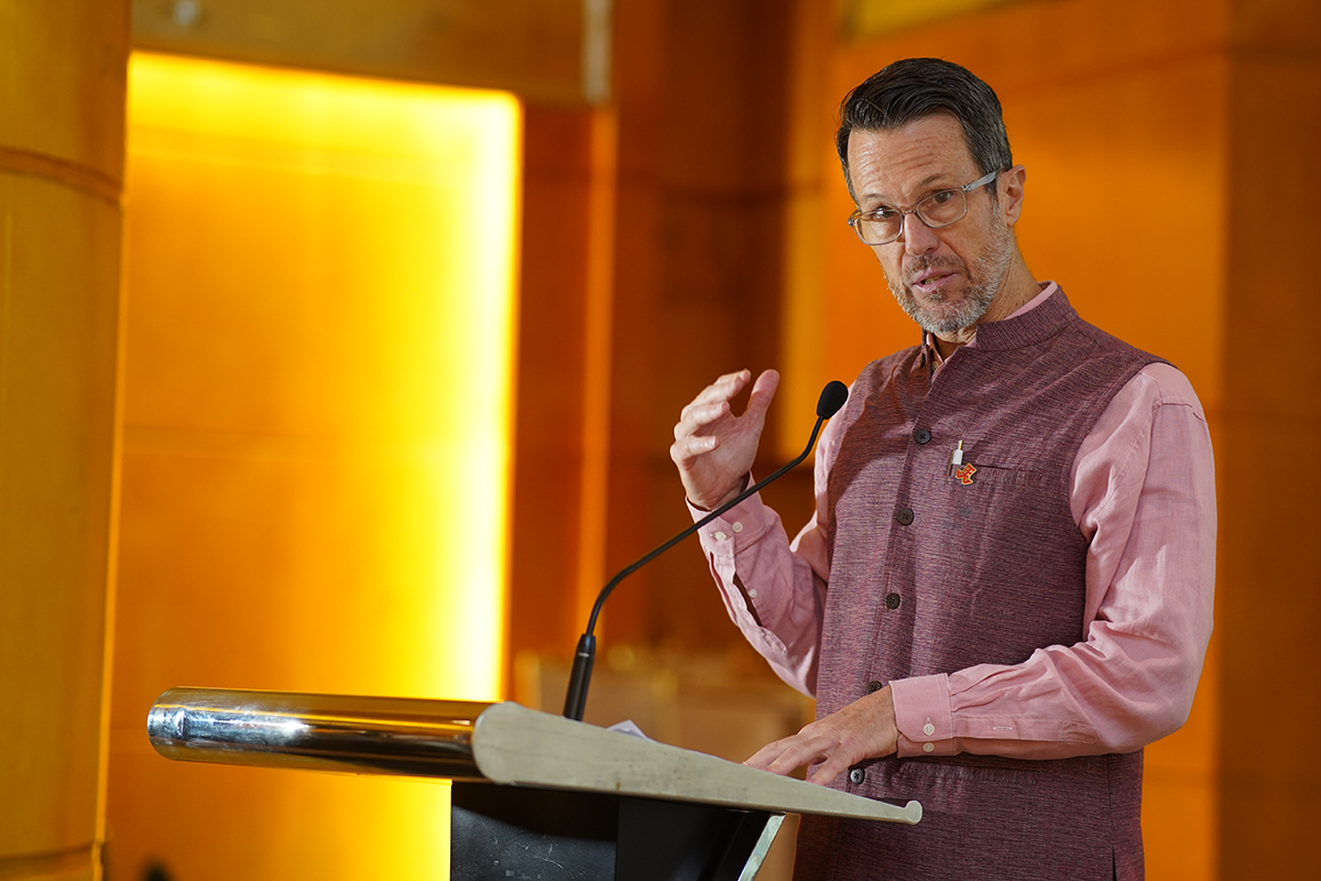 Man speaks from a podium.