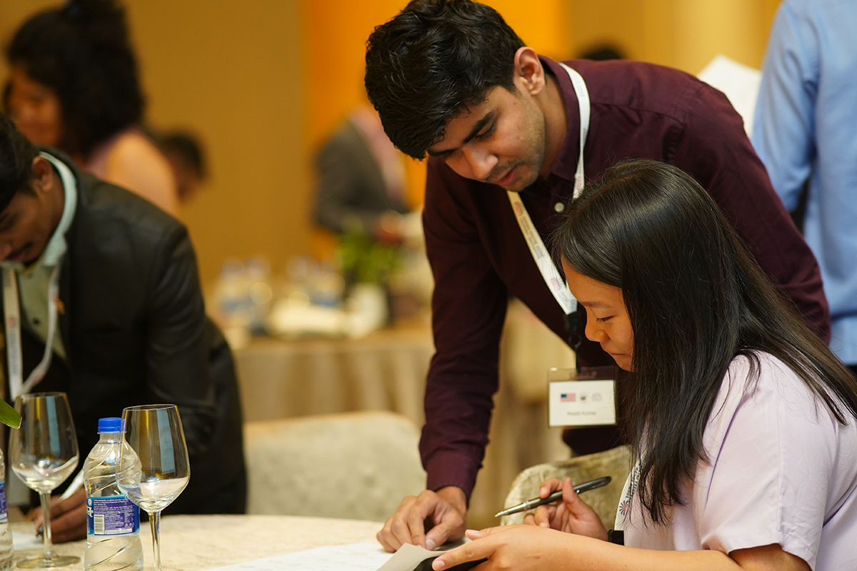 Man and woman look at a piece of paper.