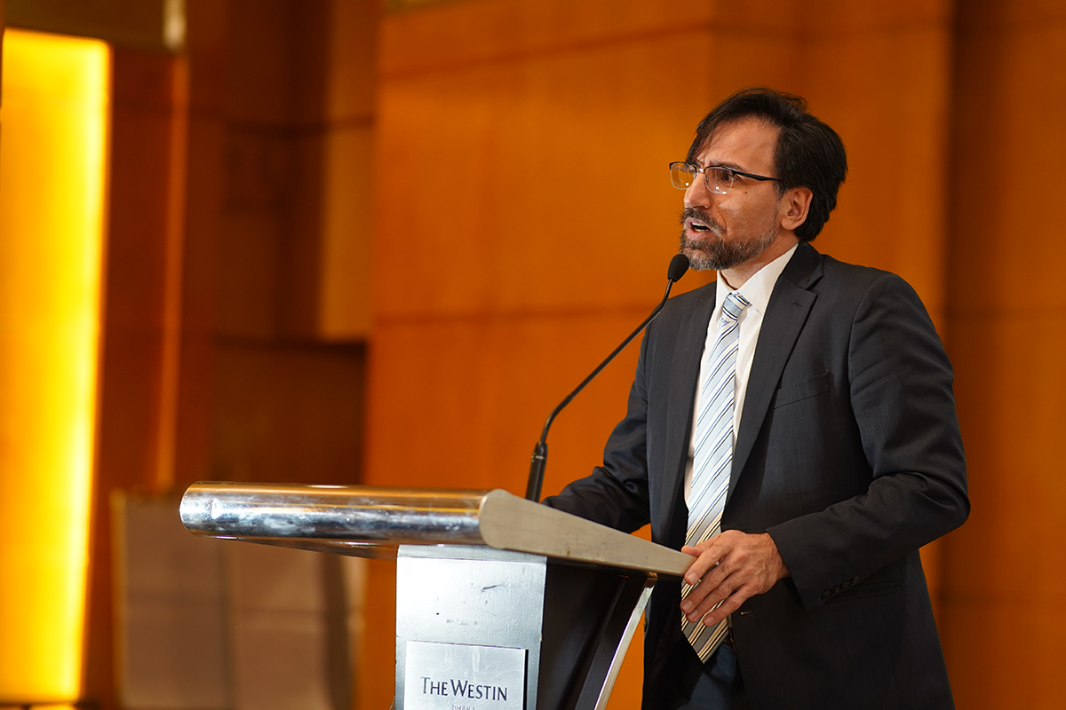Man speaks from a podium.