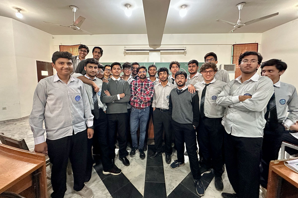 Group of young men stand together in a classroom in Pakistan.