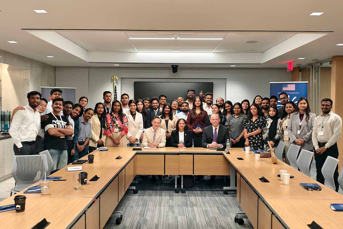 Participants pose for a group photo in the board room of the East-West center