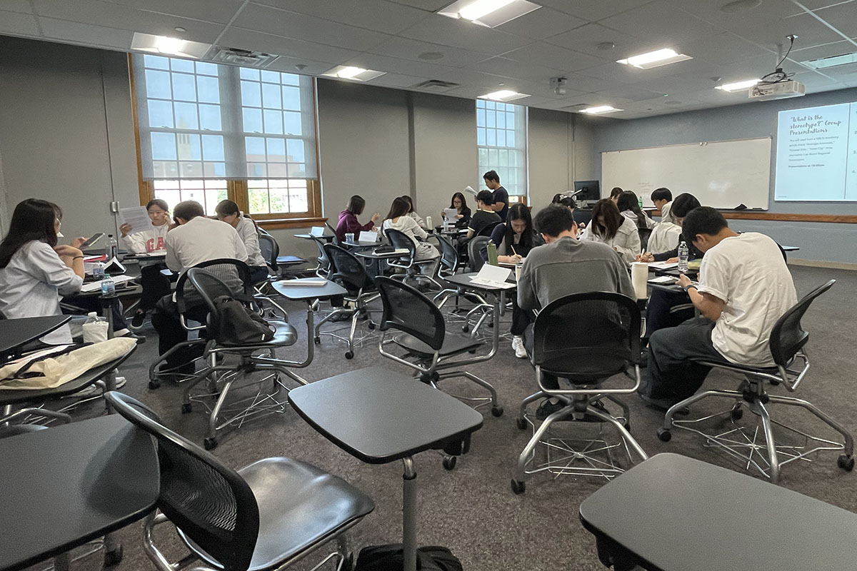 Students working together in groups in a classroom.