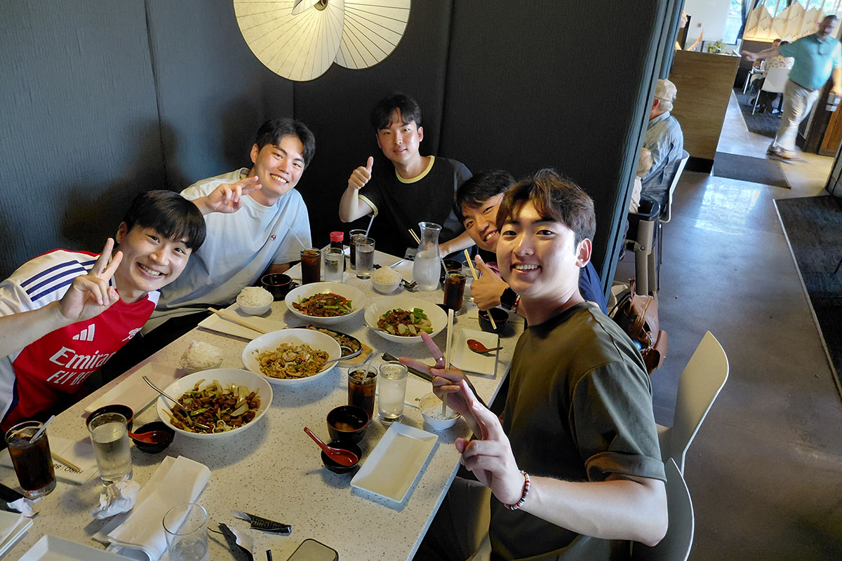 A group of male students enjoy food at a local restaurant. 